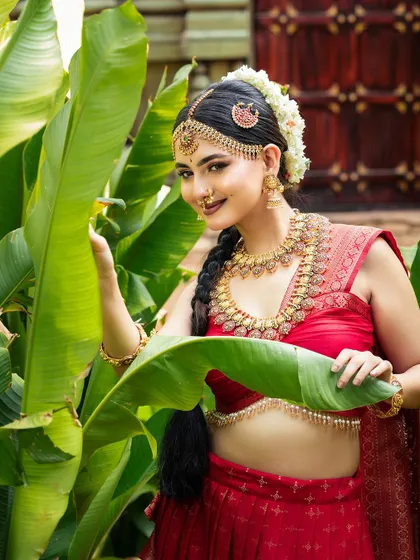 A playful and natural shot. The model is wearing a full antique set, including a traditional nose ring and jhumkas, which are all part of the rental package.