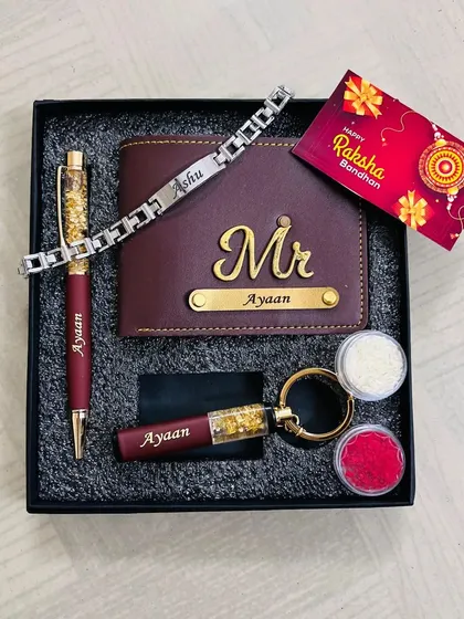 A Rakhi gift set featuring a personalized wallet, pen, keychain, and a matching bracelet-style rakhi.