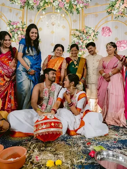 A beautiful family portrait with the couple, priest, and their loved ones after the ceremony.