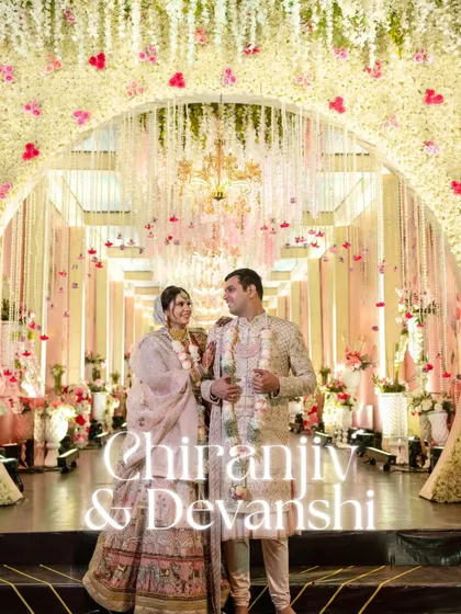 Two souls, one grand adventure. This couple stands under a magnificent floral archway, a perfect representation of their beautiful union.