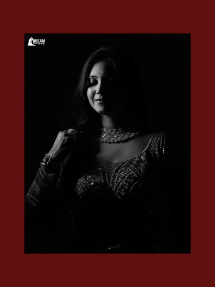 A dramatic black and white portrait of Ekta, using shadow and light to create a powerful and artistic image.
