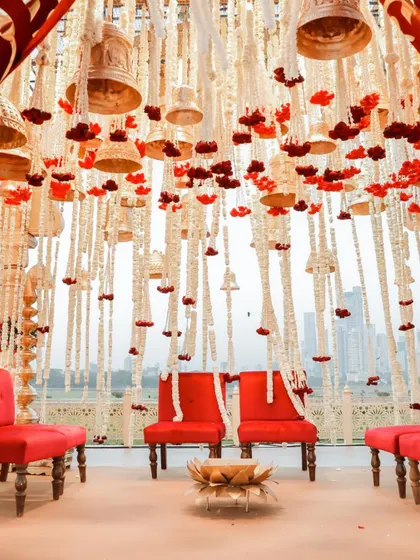 Floating florals rooted in tradition. The mandap ceiling was adorned with hanging bells and strings of tuberoses and carnations, creating a divine canopy for the couple.