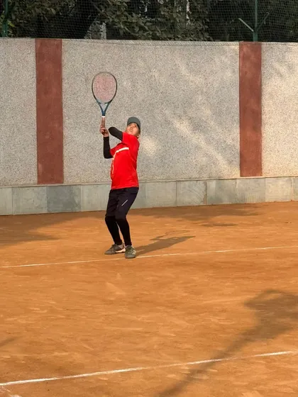 A junior player hitting a backhand with a two-handed grip. We work with each player to find the techniques that best suit their style and physique.