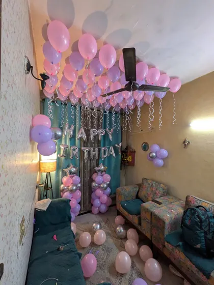 A wide-angle view of the fully decorated room, with balloons covering the ceiling and floor for a complete surprise.