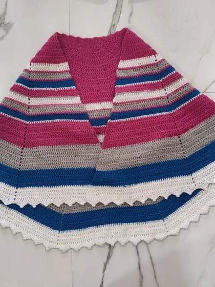 Another flat-lay view of the semi-circle shawl, highlighting the bold color blocking of fuschia, blue, grey, and white.