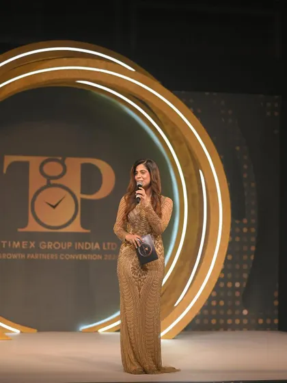 A wide shot of me on the beautifully designed stage for the Timex convention. The stage design and my presence work together to create a visually impressive experience.
