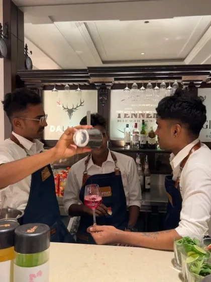 A candid shot of our bartenders sharing a laugh while crafting a drink. This image captures the fun and positive energy that our team brings to every event.