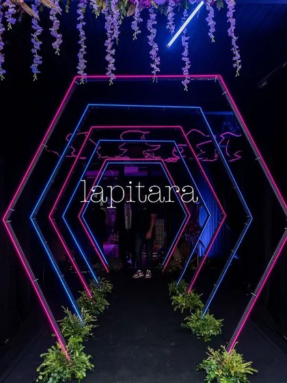 An electrifying entrance for a neon-themed party. This geometric tunnel, lit with vibrant pink and blue neon lights, creates a futuristic and high-energy vibe, guiding guests into the main event space. It demonstrates my ability to execute modern, edgy themes with precision and flair.