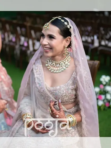 A happy, smiling portrait of the bride during her outdoor wedding ceremony.