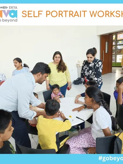 An instructor offers guidance and encouragement to a table of young artists during the Self-Portrait Workshop. My approach is nurturing and hands-on, ensuring every child feels supported in their creative journey.