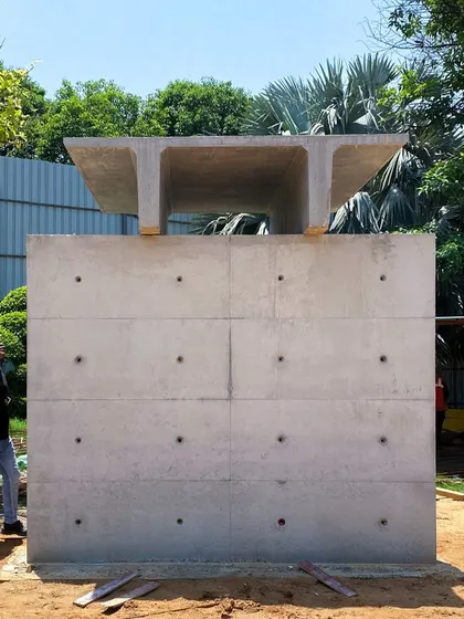 A full-scale mockup of a section of the precast farmhouse. This allows us to test the connections and visual appearance of the precast walls and the double-T roof slab before final assembly.