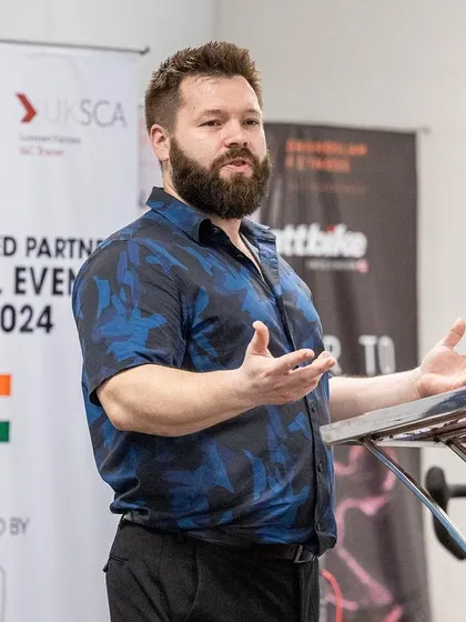 A speaker at the 2024 conference discusses his topic with passion and expertise, engaging the audience of fellow S&C professionals.