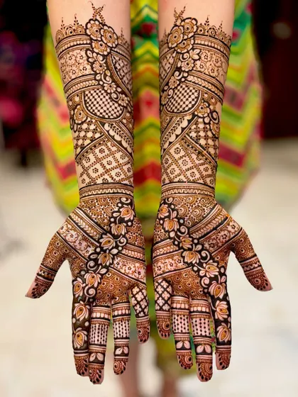 The back of the hands for the same bride, featuring a unique and beautiful floral vine pattern.