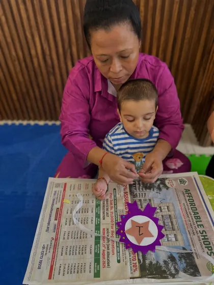 A grandparent and child are deeply focused on their craft, demonstrating how our program welcomes all caregivers to be part of the learning journey.