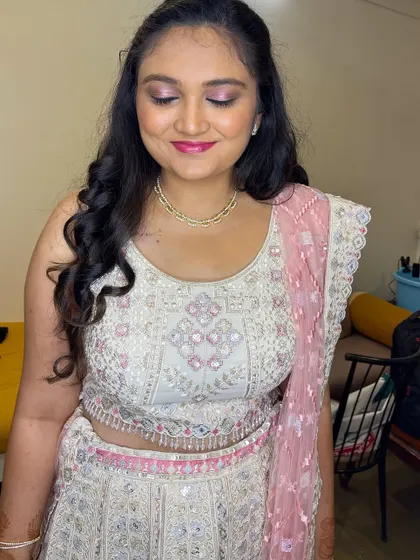 A detailed shot of Tiana's makeup. The pink and silver eyeshadow complements her lehenga perfectly, and her skin has a beautiful, dewy finish.