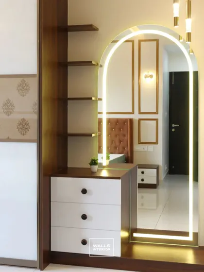 A beautiful arched mirror with backlighting serves as the centerpiece for this dressing unit. The design includes drawers and open shelving for storing cosmetics and accessories.