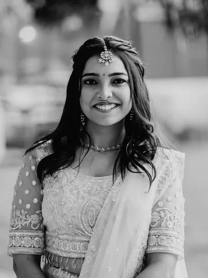 A classic black and white portrait. The makeup still looks stunning, highlighting her features and her beautiful smile.