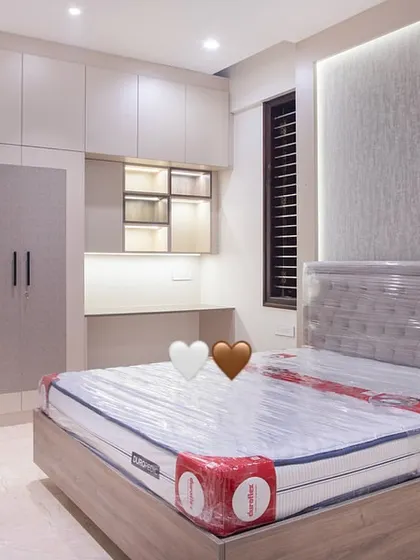 Another angle of the guest room, highlighting the tufted headboard and the custom wardrobe unit. The design ensures guests have ample storage and a comfortable space, making them feel right at home.