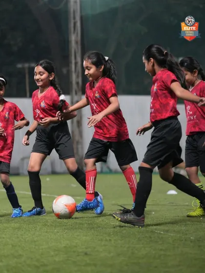 Our girls' team in action during a competitive match. We are committed to providing a platform for female athletes to shine in the football tournaments we organize.