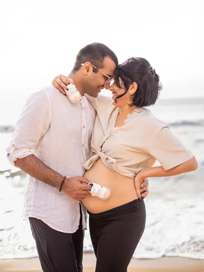 Tiny shoes for tiny feet. Using simple props like baby shoes adds a sweet and personal touch to your couple portraits, symbolizing the little one you're eagerly waiting for.