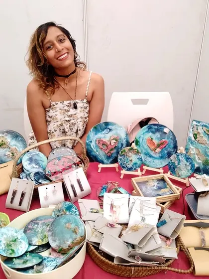 Me at my pop-up stall, surrounded by my handmade resin creations. I love meeting people at markets and sharing the stories behind my art.