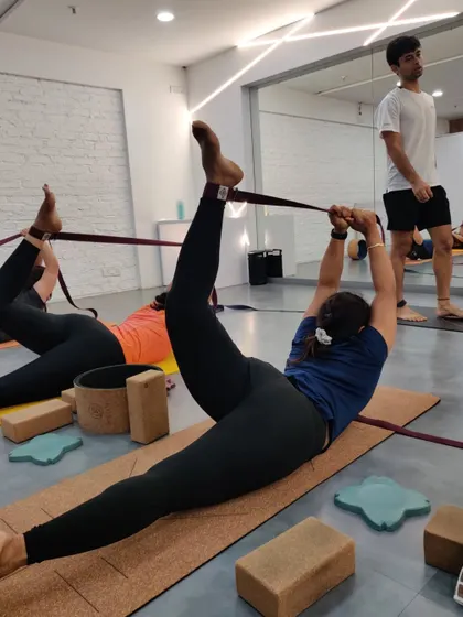 In this workshop, a student practices Supta Padangusthasana with a strap. This supported hamstring stretch is excellent for releasing tension in the lower back and improving flexibility in the legs.