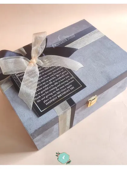 A stylish grey suede box with a personalized message tag. This is one of my most popular options for creating a classy and modern gift hamper.