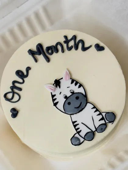 A cute bento-style cake for a one-month milestone. This small cake features a hand-painted baby zebra.