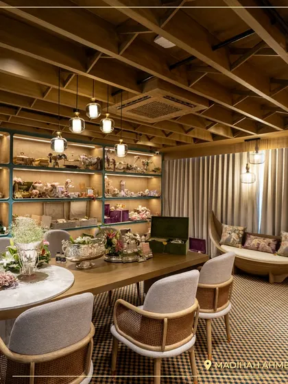 The elegant interior of the Madihah Ahmedabad store, designed to make you feel welcome and inspired. The shelves are filled with curated hampers and decor pieces.