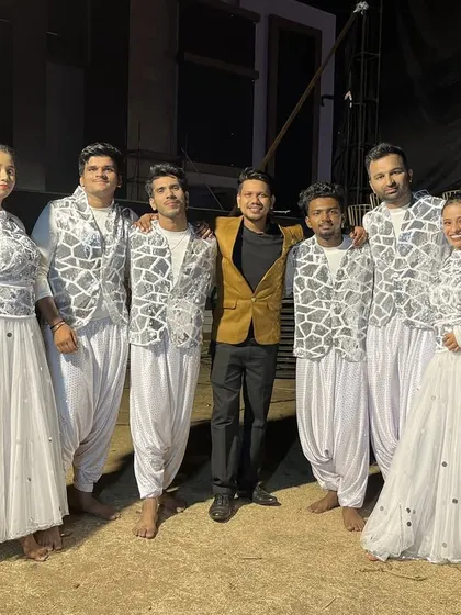 The team in elegant white and silver outfits, ready for another grand Sangeet performance. We coordinate costumes to match the theme of your event perfectly.