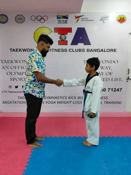 A handshake for a new blue belt.