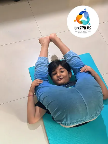 This young client shows amazing flexibility, demonstrating a pose that requires open hips and a strong core.