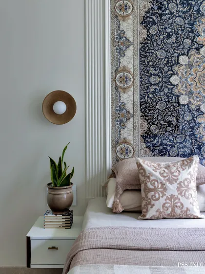This bedroom is a perfect blend of functionality and luxury. The intricate tapestry headboard, modern brass wall sconce, and fluted wall panels create a space that feels both serene and sophisticated.