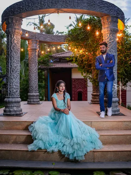 A stylish couple poses at our stone gazebo at dusk, with the lights just beginning to glow.