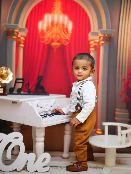Another shot of the little pianist, this time standing and looking straight at the camera.