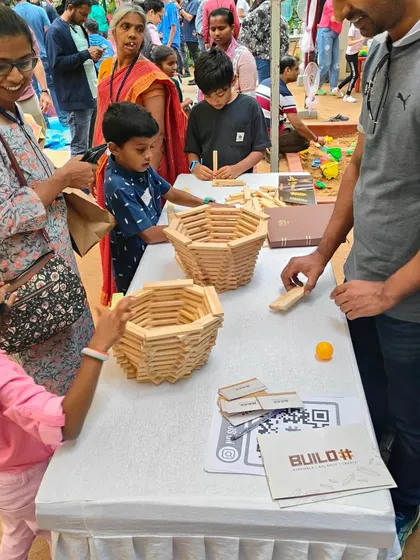 A busy table at one of our events, with parents and children all reaching for blocks and contributing to various projects. This is what we love to see: a shared space for hands-on, collaborative fun.