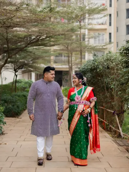 A candid shot of the couple walking and sharing a happy moment together on a paved path, showcasing the relaxed and natural style of my photography.