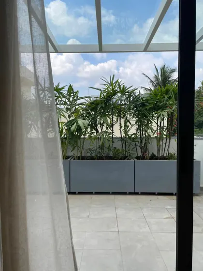 The terrace provides a private outdoor space, with planters creating a green buffer from the city.