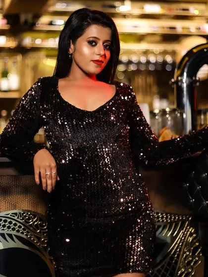 A glamorous party look for a photoshoot. This features a bold red lip and smokey eye makeup that stands out, paired with a sleek hairstyle for a modern and chic vibe.