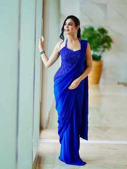 A full-length view of a stunning royal blue pre-draped saree, perfect for an awards night or a modern wedding reception.