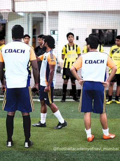My coaching staff discussing strategy during a training session. We work as a team to provide the best possible guidance for our players.