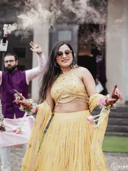 The bride makes a cool entrance to her Haldi party, dancing with sunglasses on. I capture the personality and style of each event.
