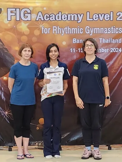 Receiving my certificate for the FIG Academy Level 2 program. This advanced training helps me bring the latest coaching techniques and knowledge back to my academy.