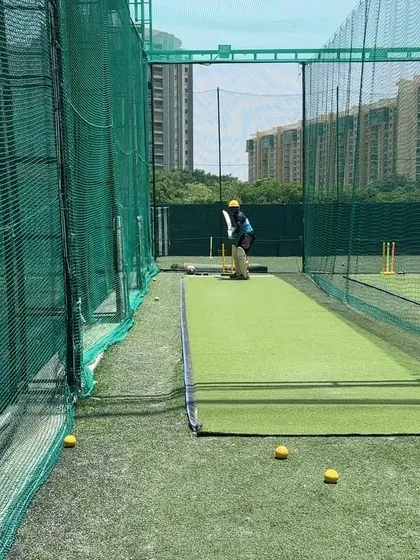 The batsman prepares to play a shot in the nets.
