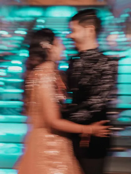 An artistic motion-blur photo from an evening event, capturing the energy and excitement of the celebration in a vibrant, abstract way.