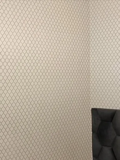 A corner shot showing the seamless application of the trellis wallpaper.