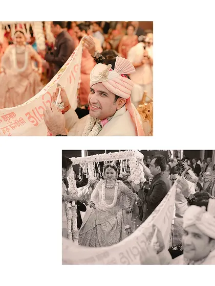 The moment the bride and groom first see each other during the ceremony, separated by the traditional antarpat. The anticipation is palpable.