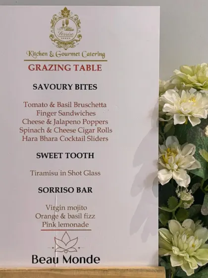 A custom menu designed for a Beau Monde Clinics event. The menu lists a selection of savory bites like bruschetta and spinach cheese cigar rolls, as well as sweet treats and refreshing drinks from the Sorriso Bar.