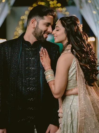 A beautiful portrait of Zaee and Kartik from their Sangeet, with the soft bokeh of the background lights adding a touch of magic.