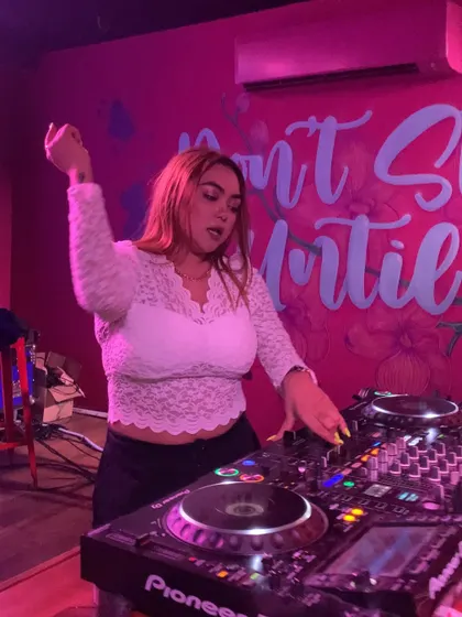 Hand in the air, feeling the beat as I work the mixer.